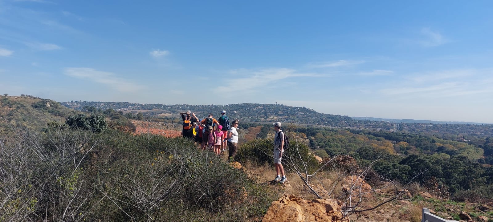 Children and adults gathered at a viewpoint