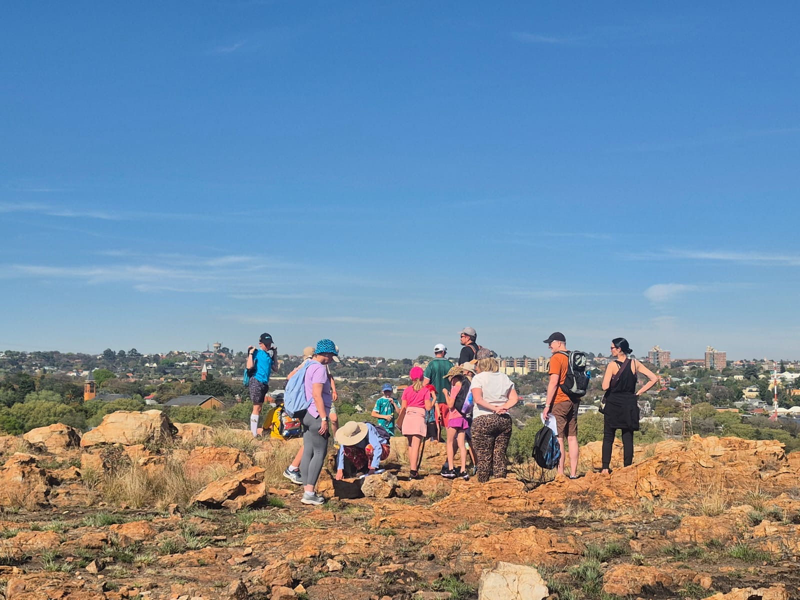 Visitors learning together on the rocky Koppies